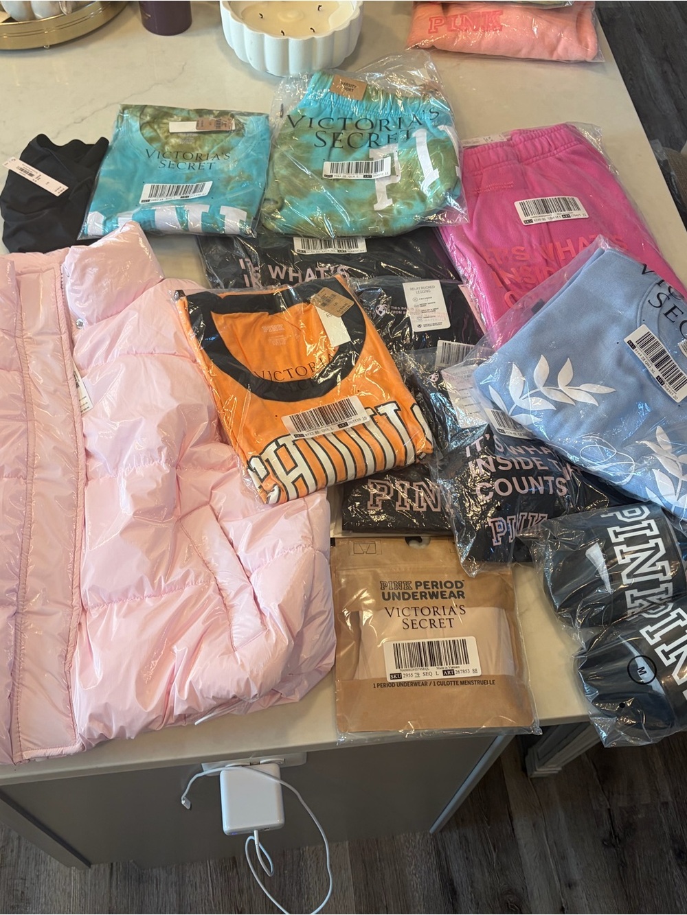 Pink puffer vest, t-shirts, full zip top, leggings, sweatshirt, shorts, sandals